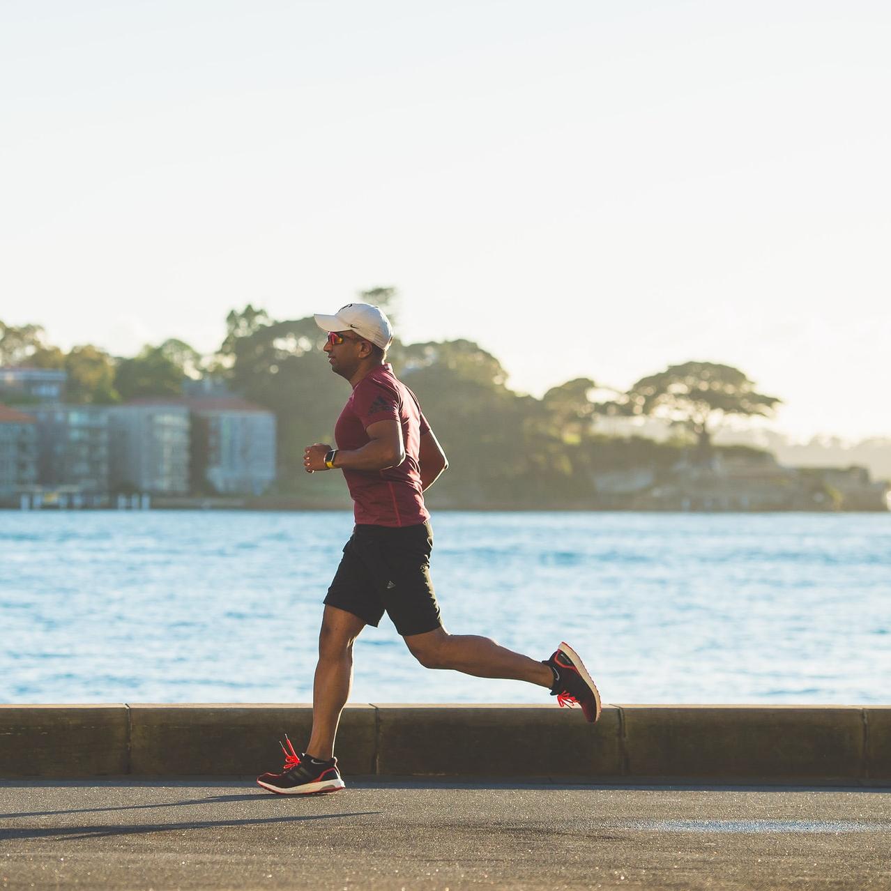 man running near sea during daytime